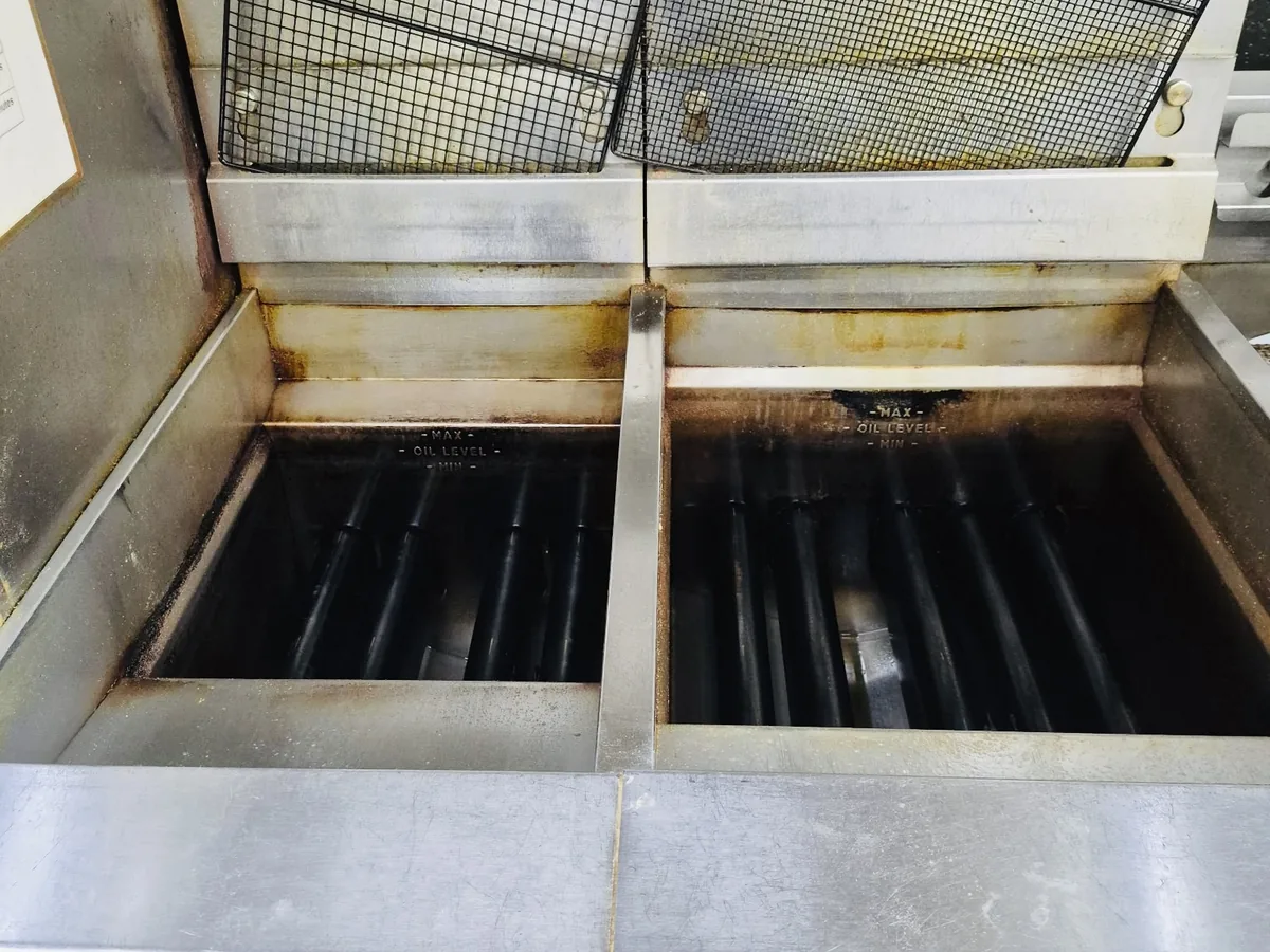 Kitchen exhaust hood grease trough full of accumulated grease before cleaning