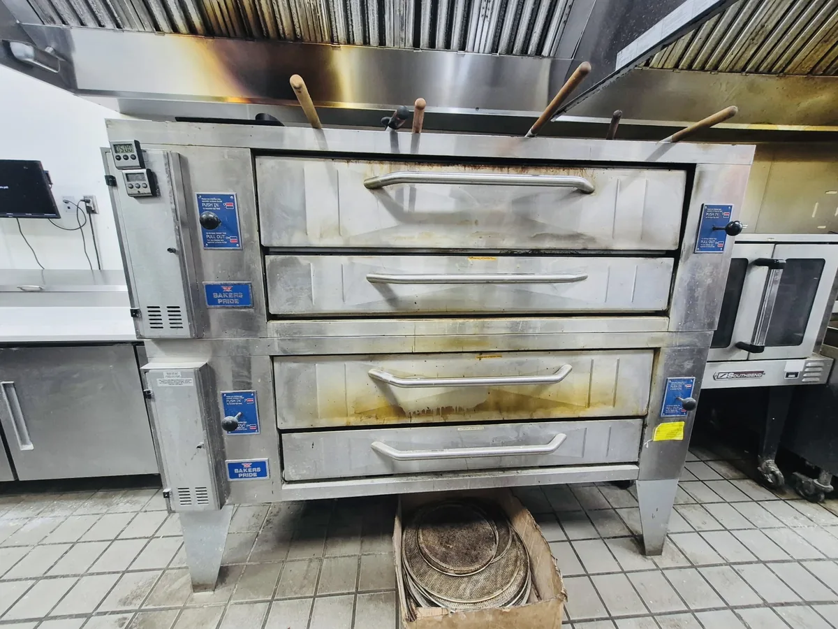 Pizza deck oven covered in baked-on grease before cleaning
